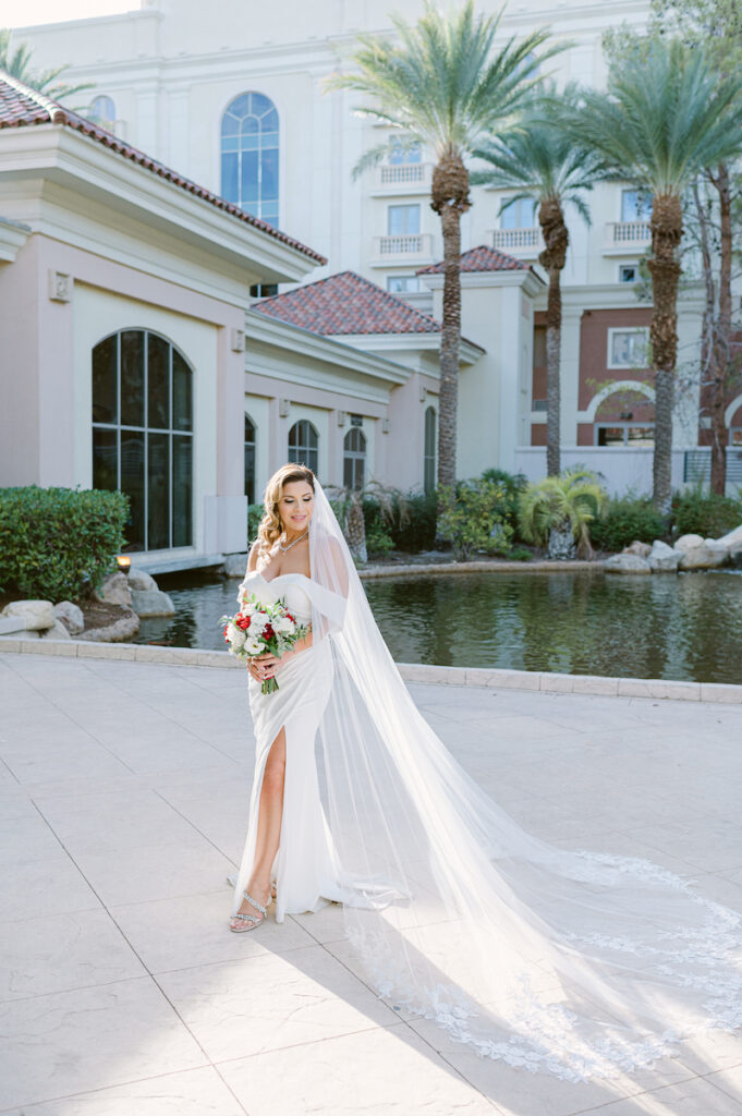 bride posing with bridal bouquet on patio at JW Marriott Las Vegas Photography Photographer