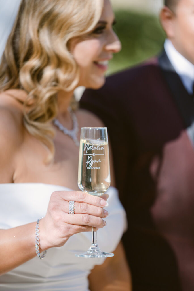 bride holding custom champagne glass at wedding reception at jw marriott hotel