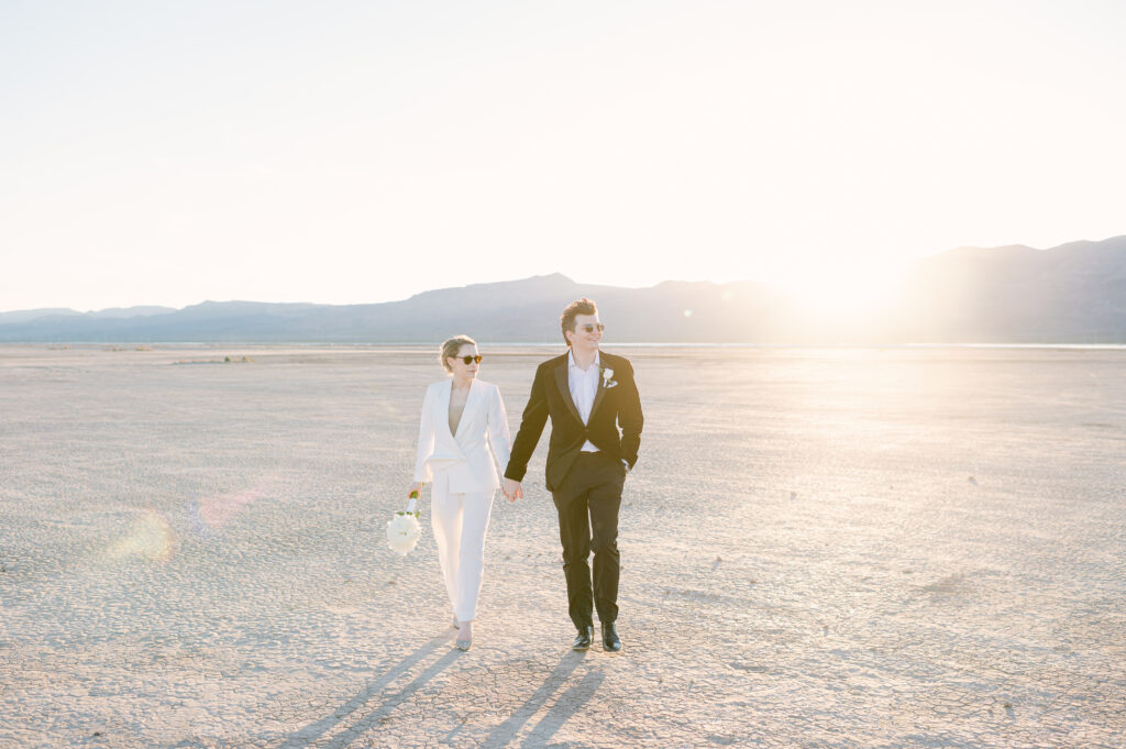 Wedding couple walking in dry lake bed Las Vegas, NV with sunset backdrop Las Vegas Portrait Photography