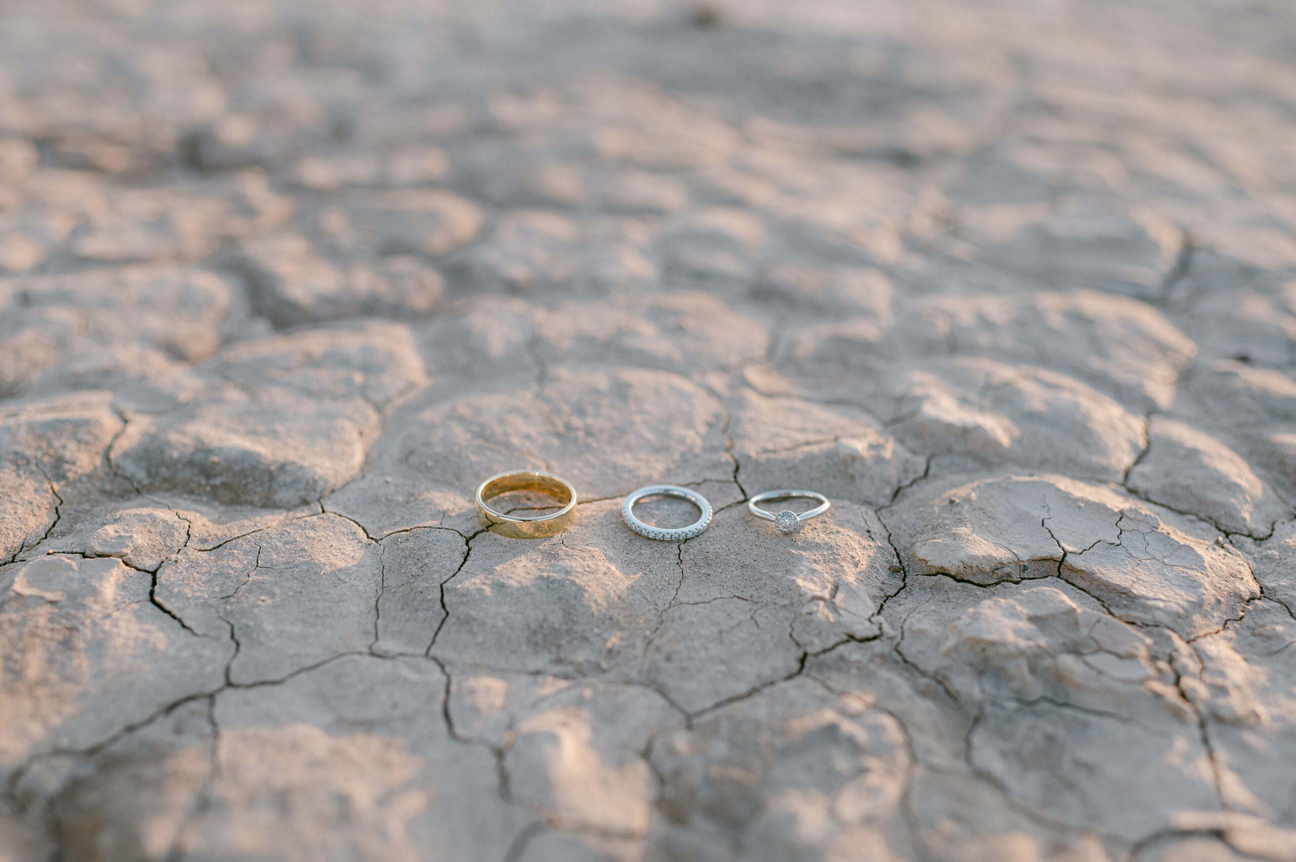 wedding rings on dry lake bed floor