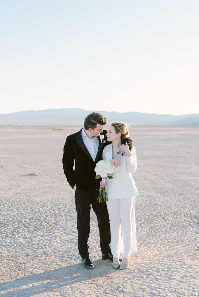 Wedding couple walking in dry lake bed in Las Vegas, NV
