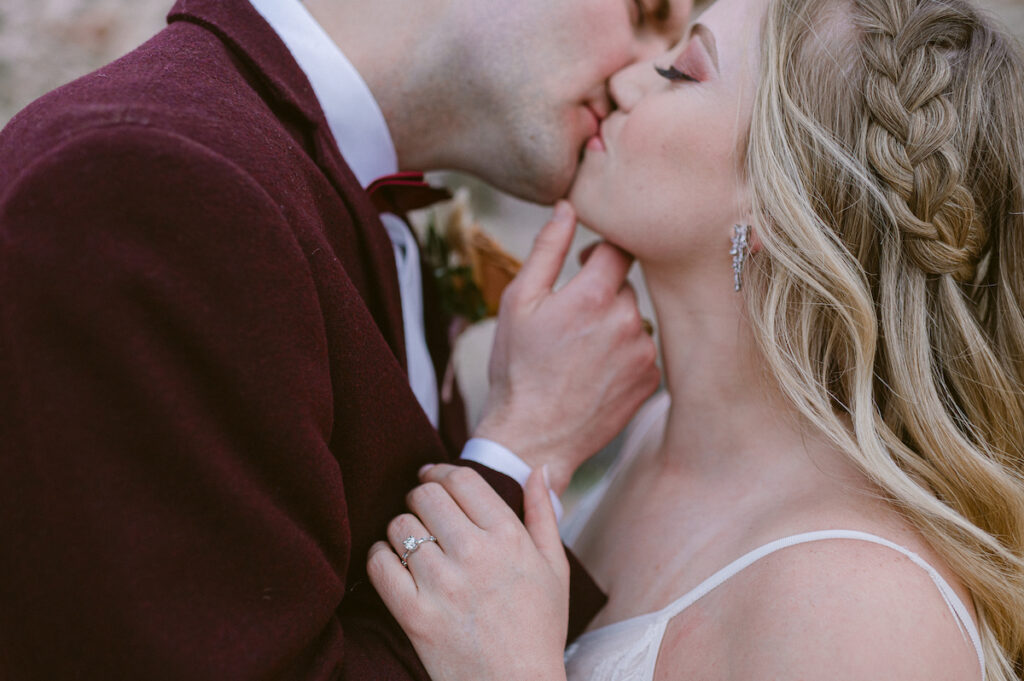 bride and groom kissing close up photo with wedding ring and earring